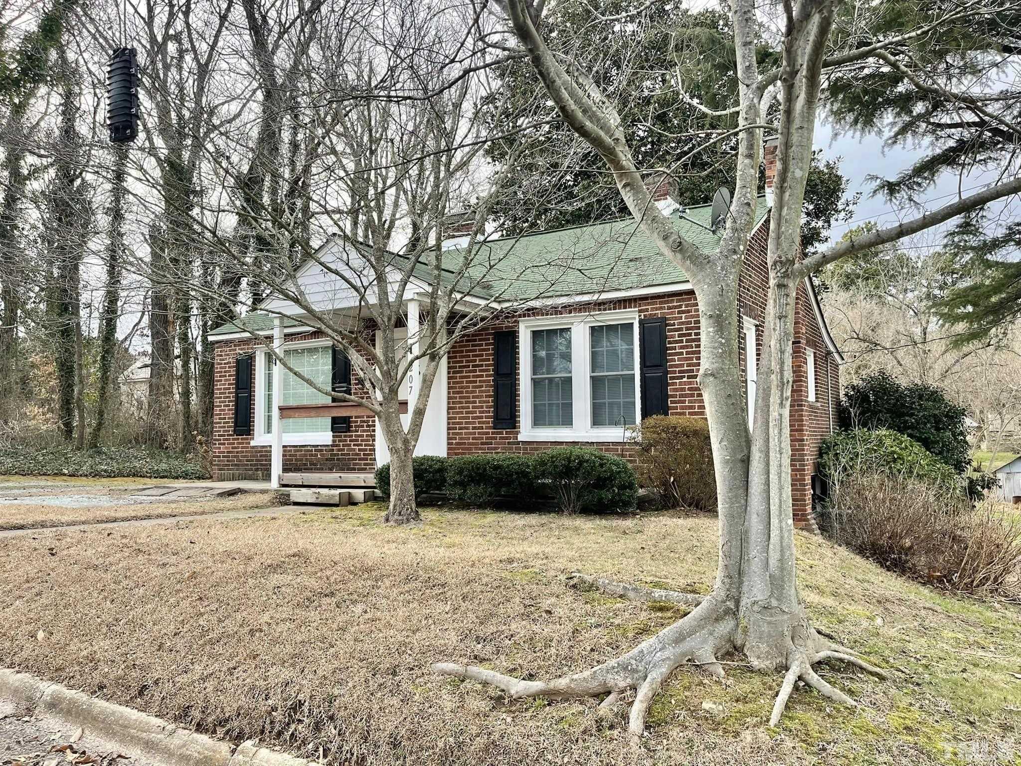 207 Broad Street Roxboro, NC 27573 - Photo 1 of 17 a front view of a house with garden