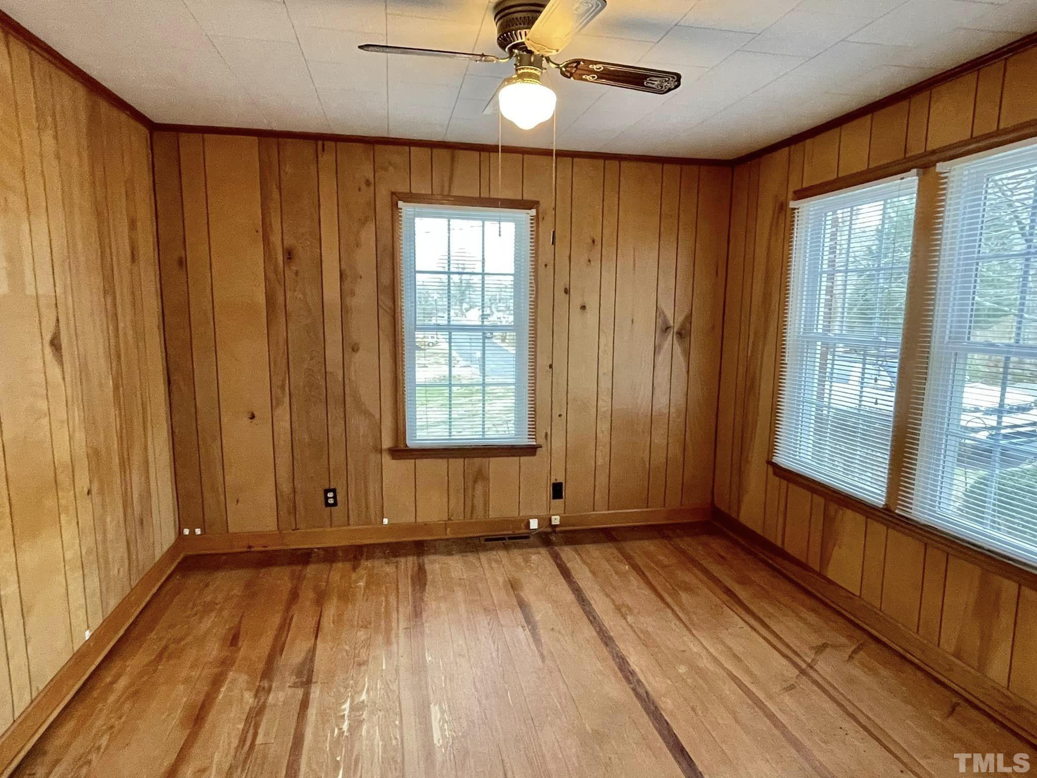 207 Broad Street Roxboro, NC 27573 - Photo 5 of 17 wooden floor in an empty room with a window