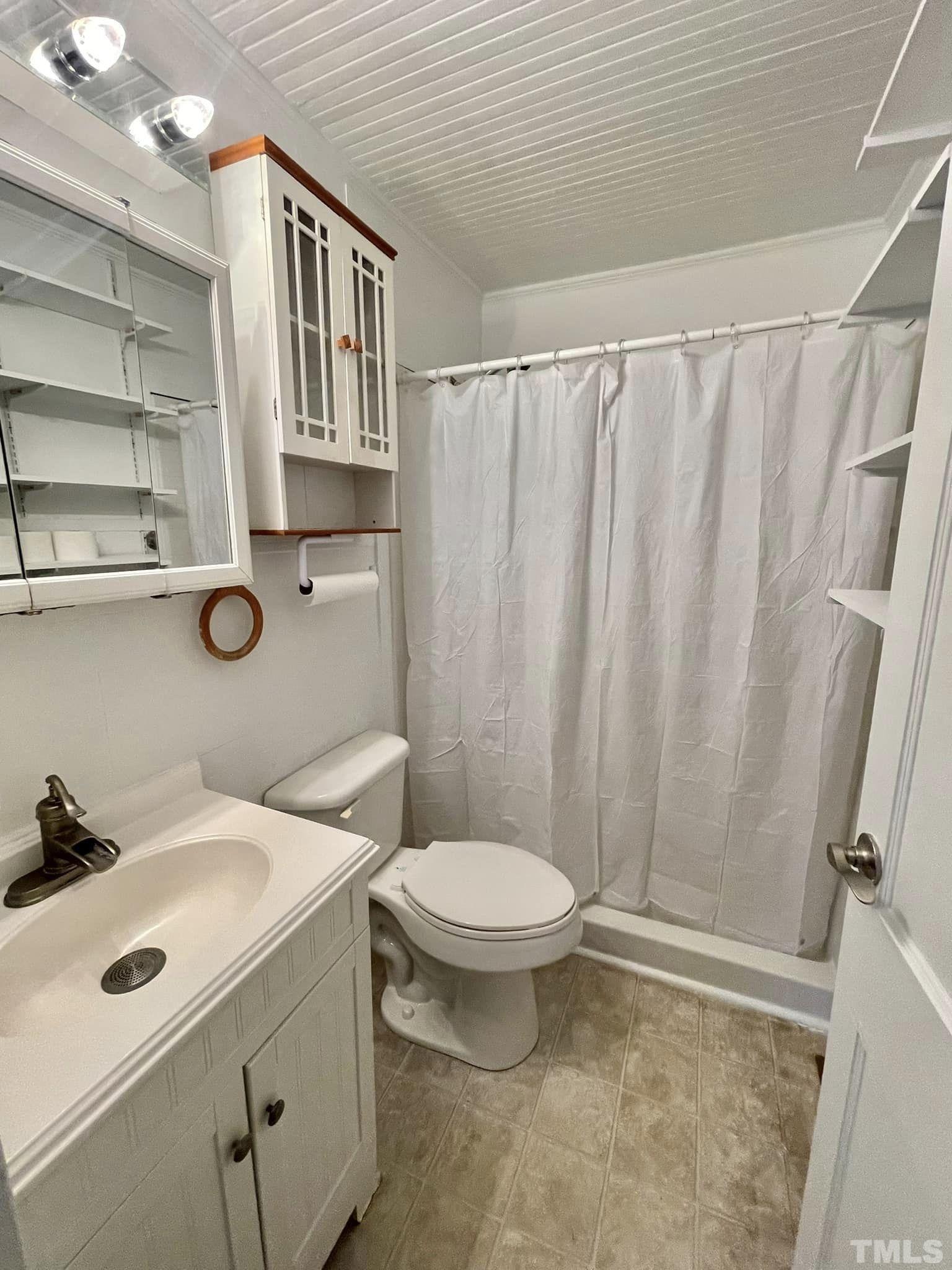 207 Broad Street Roxboro, NC 27573 - Photo 7 of 17 a bathroom with a toilet sink and shower