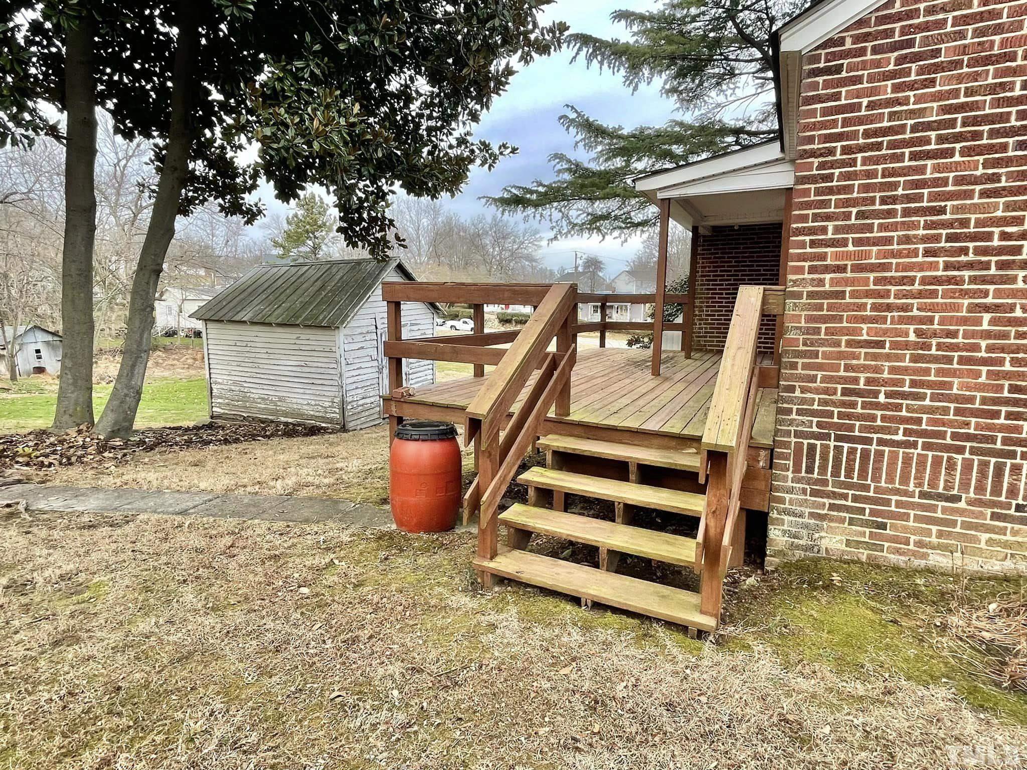 207 Broad Street Roxboro, NC 27573 - Photo 10 of 17 a view of a backyard with a deck