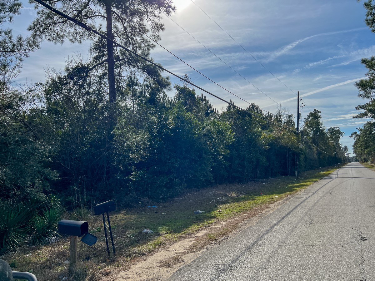 0 Fresenius Road Silsbee, TX 77656 - Photo 12 of 13 a backyard of a house with table and chairs under an umbrella