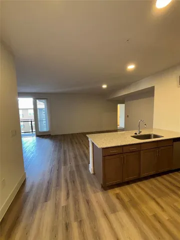 a view of a kitchen with wooden floor
