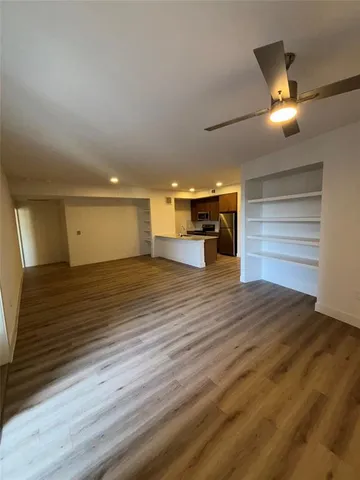 a view of a room with wooden floor