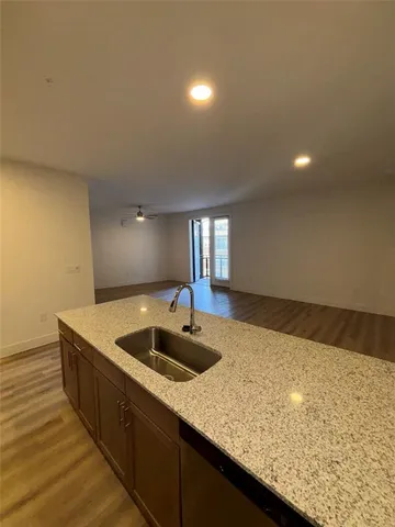 a kitchen with kitchen island sink and faucet