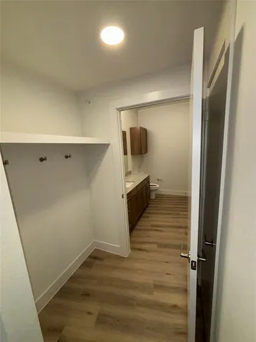 a view of a refrigerator in kitchen and an empty room