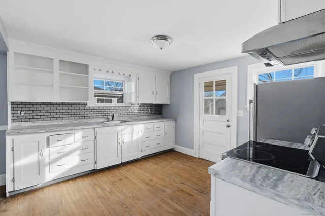 a kitchen with granite countertop a sink and cabinets