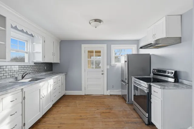 a kitchen with stainless steel appliances a refrigerator sink and stove