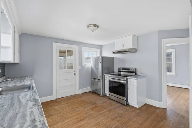 a kitchen with stainless steel appliances granite countertop a stove and a refrigerator