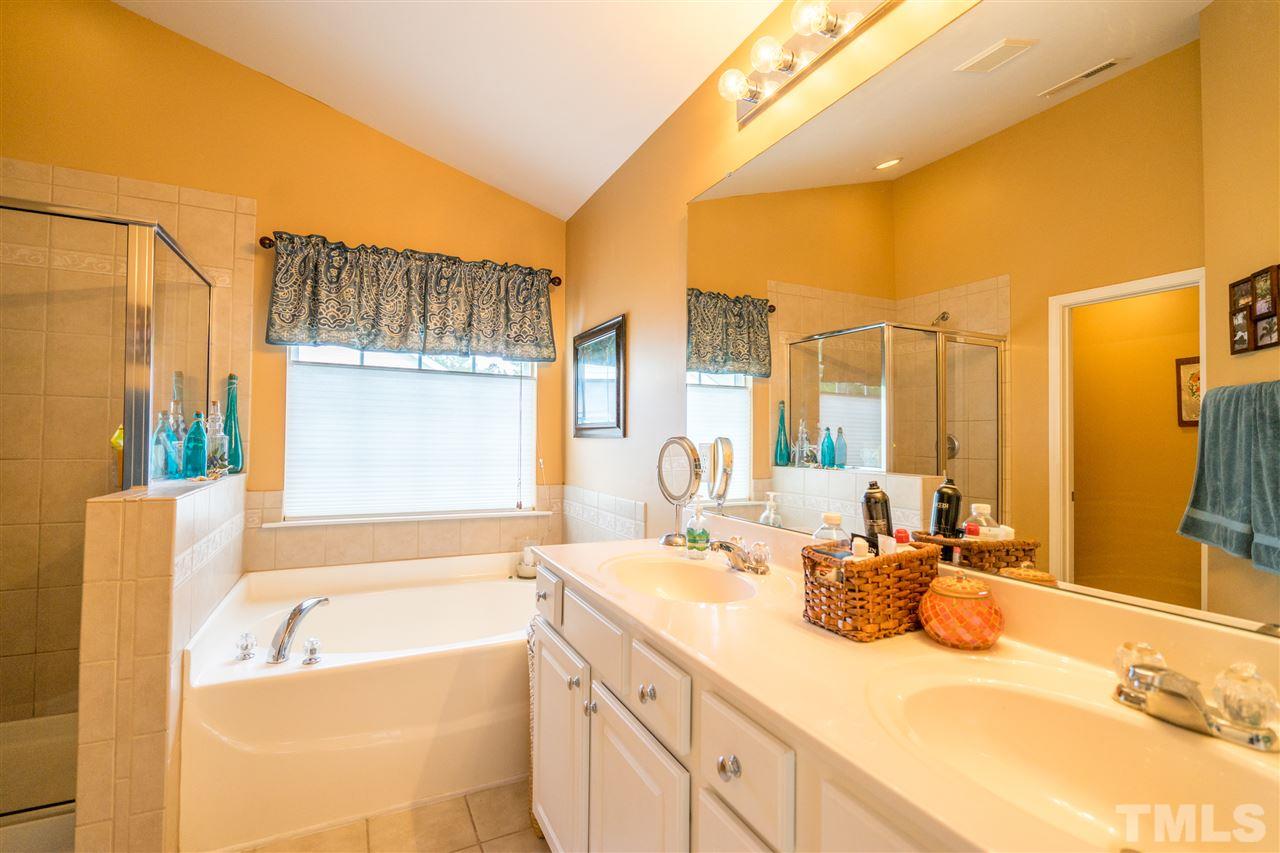 3307 Ranbir Drive Durham, NC 27713 - Photo 14 of 25 a bathroom with a tub sink and mirror