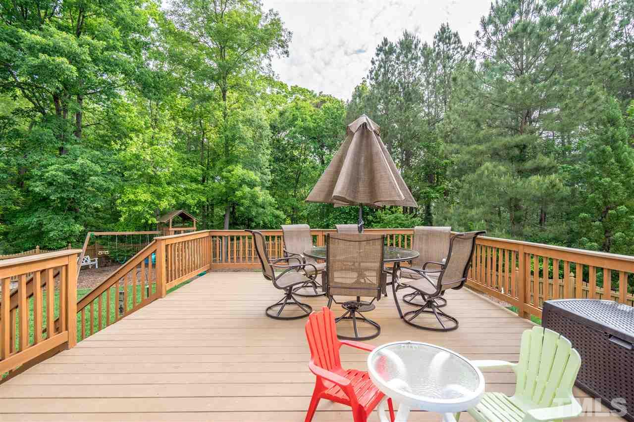 3307 Ranbir Drive Durham, NC 27713 - Photo 22 of 25 a view of deck with furniture and trees in the background