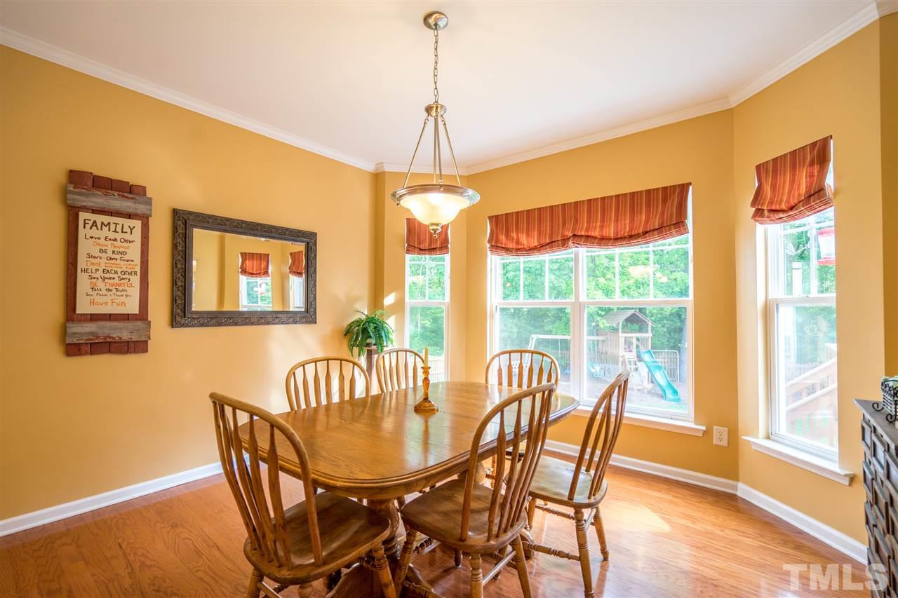 3307 Ranbir Drive Durham, NC 27713 - Photo 8 of 25 a view of a dining room with furniture window and wooden floor