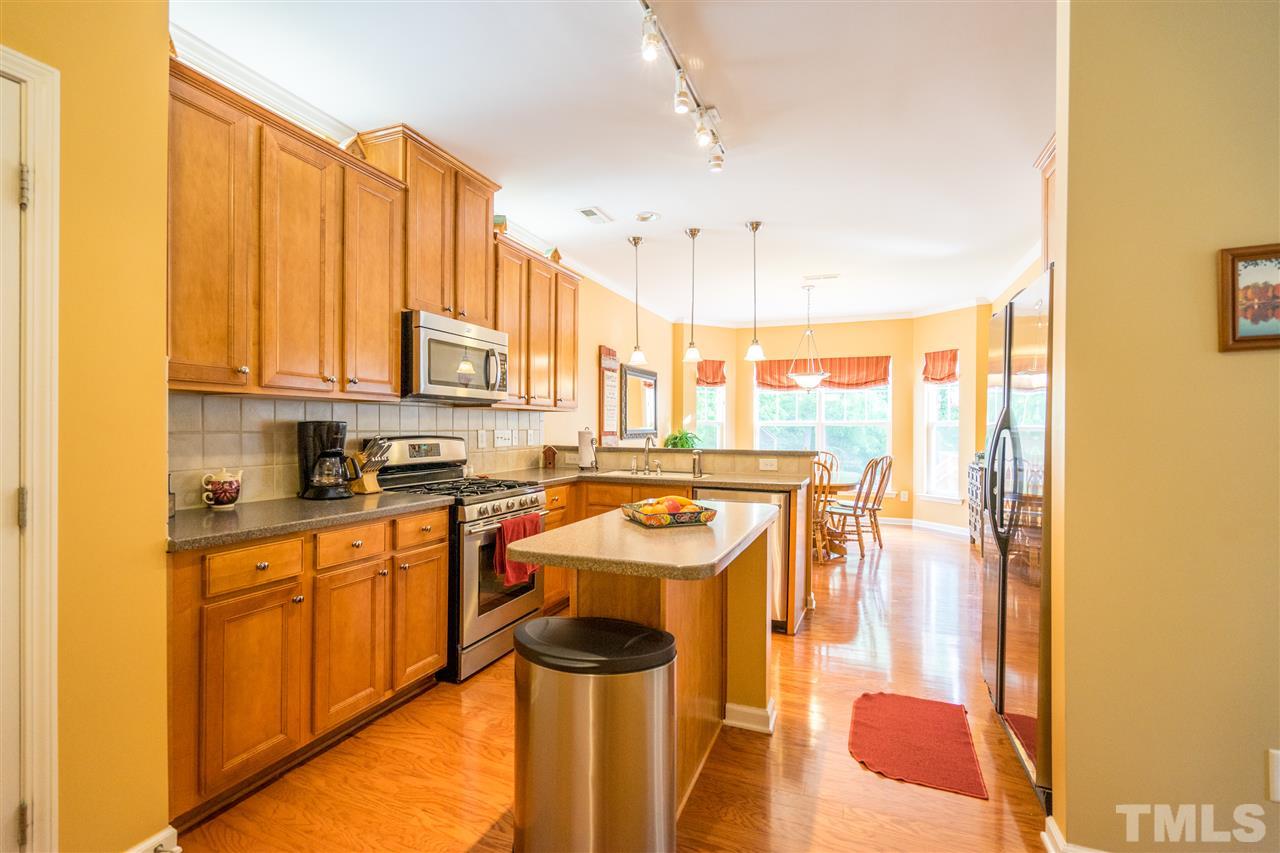 3307 Ranbir Drive Durham, NC 27713 - Photo 9 of 25 a kitchen with stainless steel appliances granite countertop a sink a stove and a refrigerator