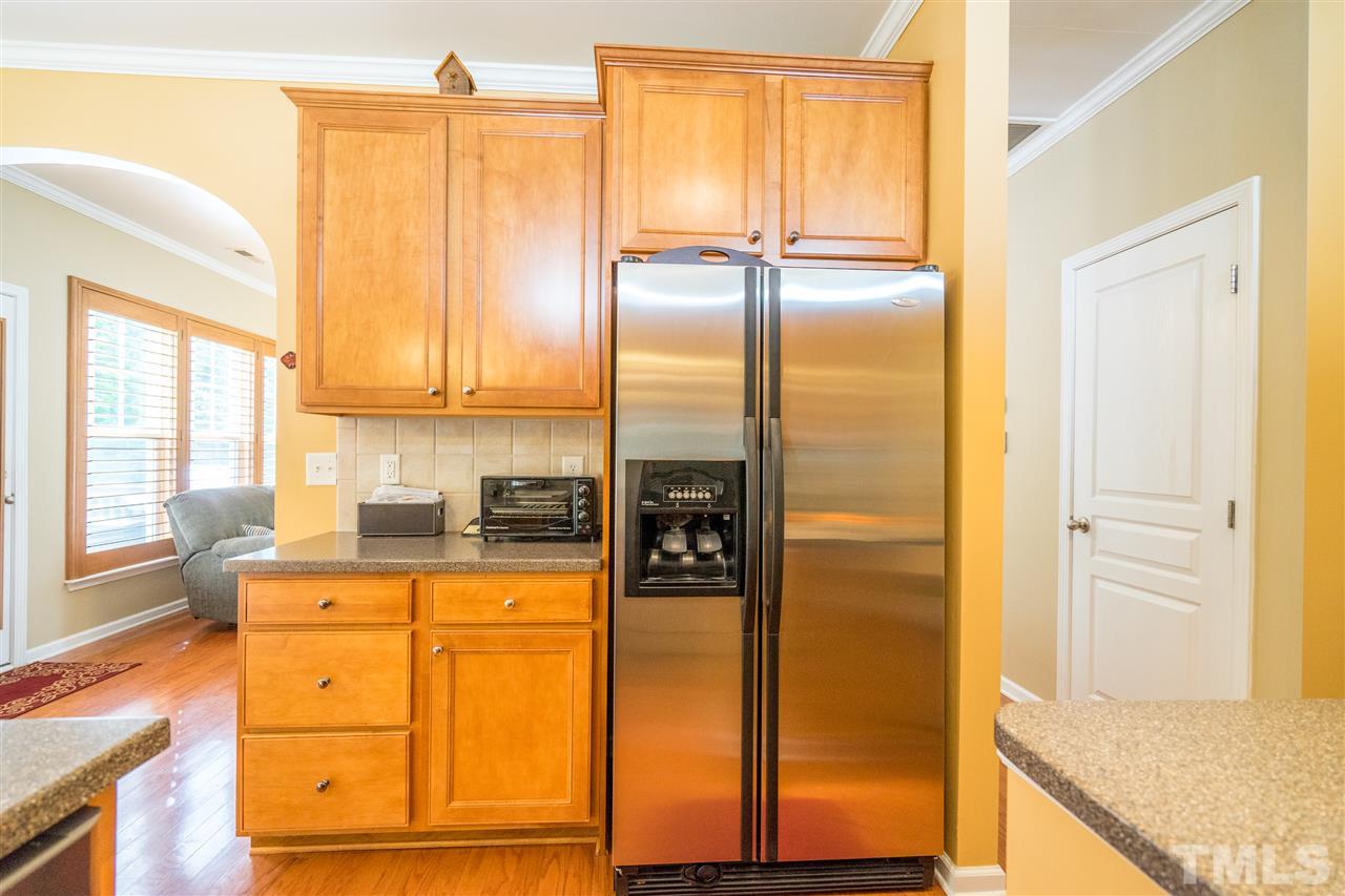 3307 Ranbir Drive Durham, NC 27713 - Photo 10 of 25 a kitchen with granite countertop cabinets and appliances with wooden floor