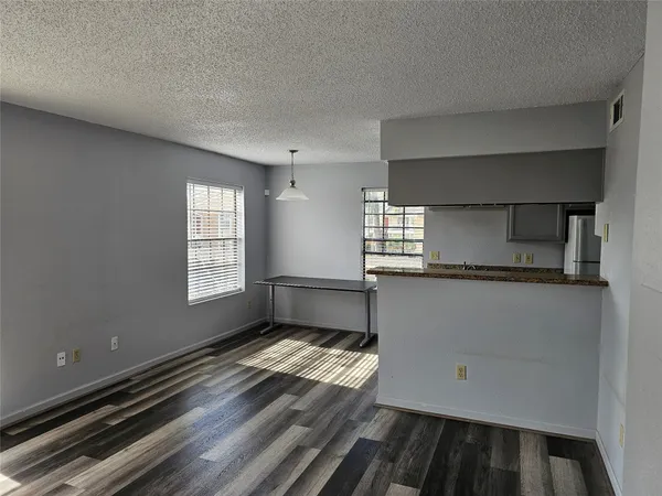 a kitchen with granite countertop a sink and a stove top oven