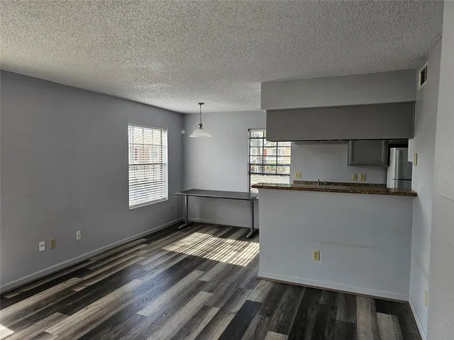 a kitchen with granite countertop a sink and a stove top oven