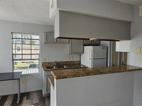 a view of a kitchen cabinets and a wooden floor