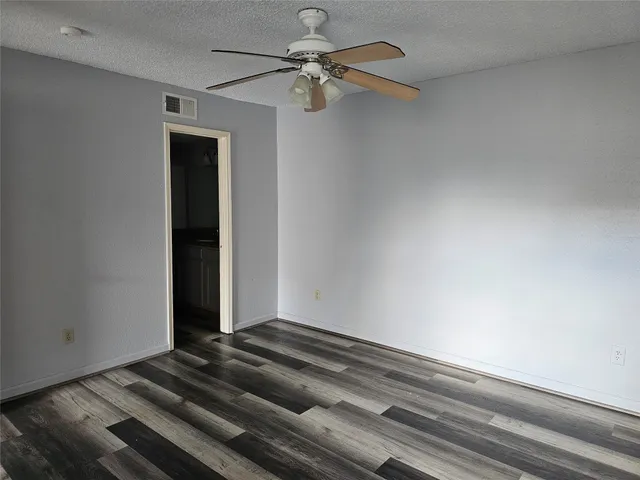 a view of a kitchen with wooden floor and stairs