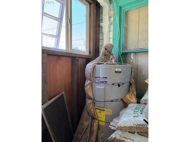 a toilet sitting in a bathroom next to a window