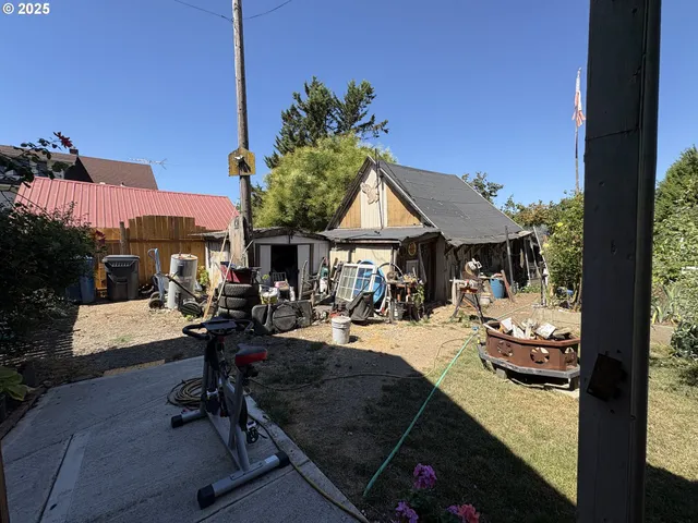 a view of a patio with dining table and chairs with a small yard