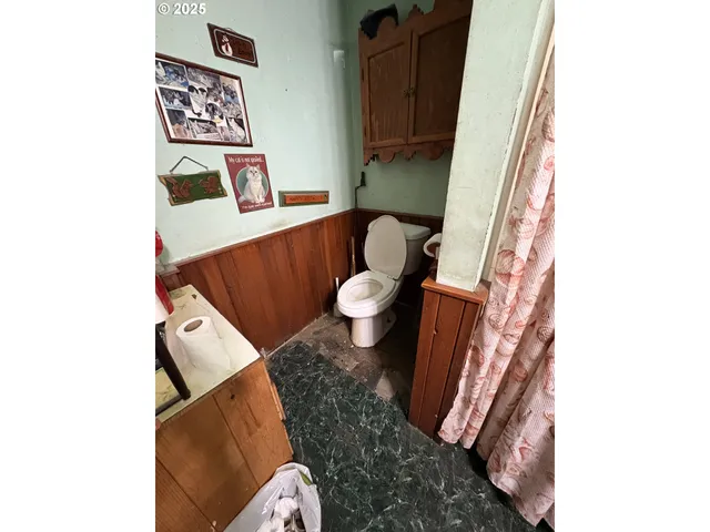 a living room with furniture and a toilet