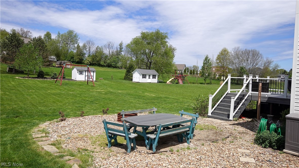 4849 Edson Road Kent, OH 44240 - Photo 41 of 50 View of yard featuring a wooden deck and a storage unit