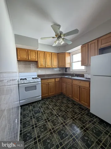 a kitchen with a sink a stove a microwave and cabinets