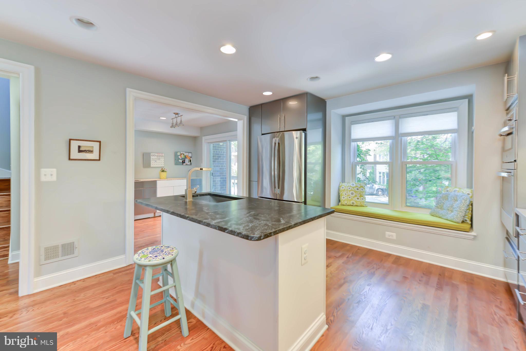 2126 Military Road Arlington, VA 22207 - Photo 18 of 29 a hall with kitchen island granite countertop a sink and a large window
