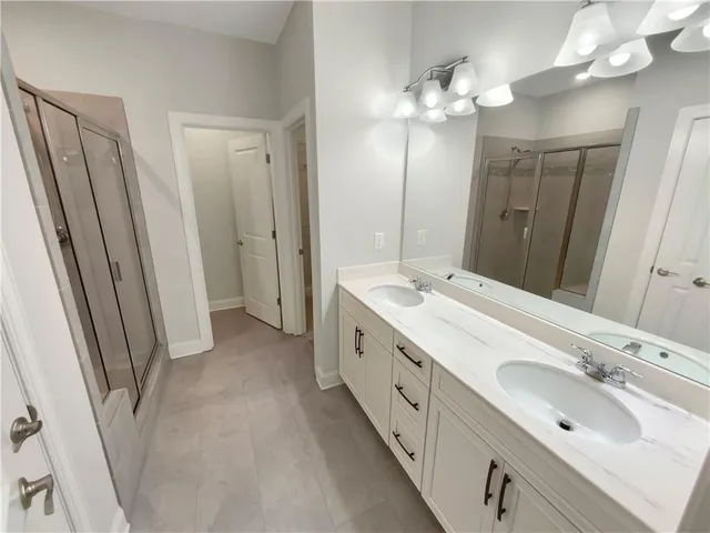 a spacious bathroom with a double vanity sink and a mirror