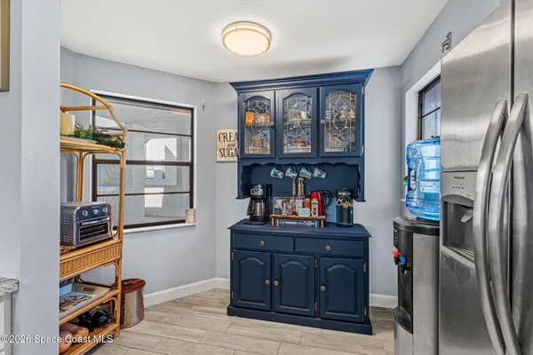 a kitchen with granite countertop a sink a stove and cabinets