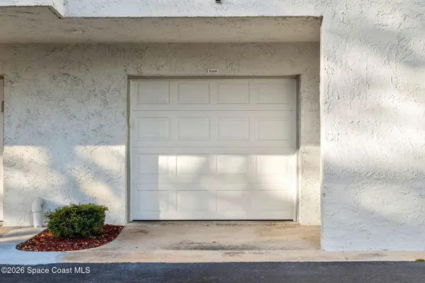 a view of a swimming pool with a chair and table in the patio