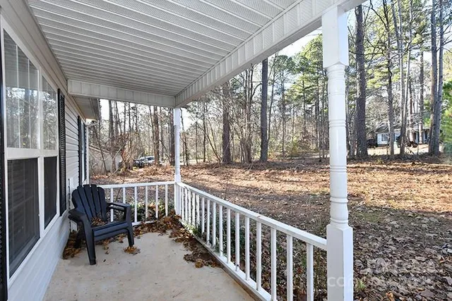a view of a porch with furniture and wooden deck