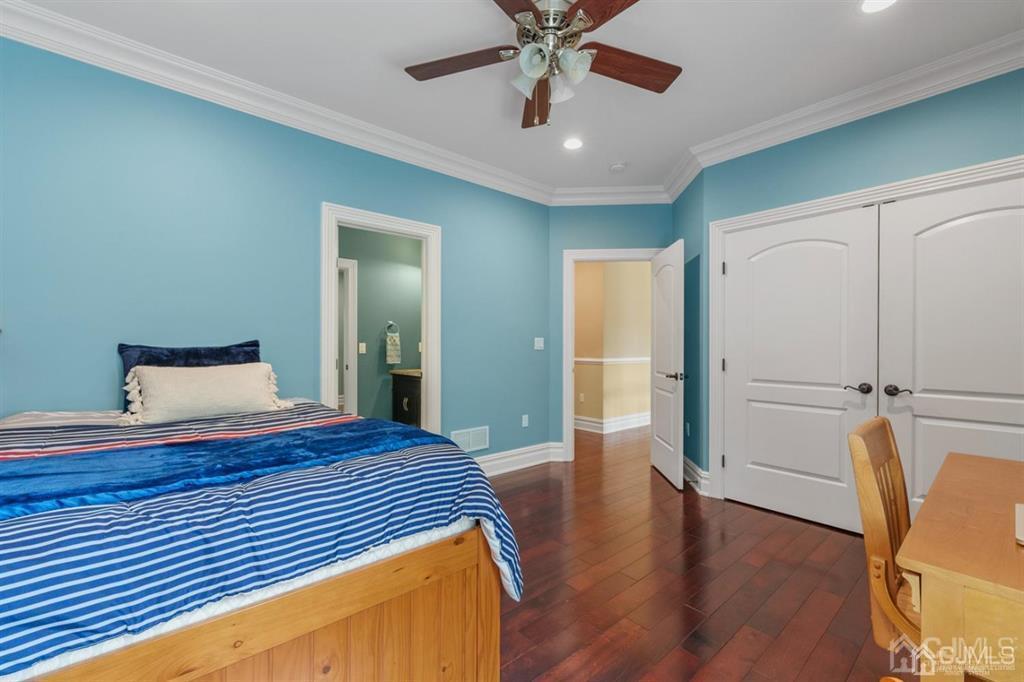 31 Round Top Road Warren, NJ 07059 - Photo 20 of 39 a bedroom with wooden floor and a chandelier