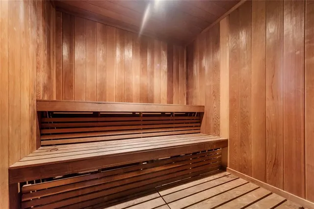 a view of a bedroom with wooden floor and a bed
