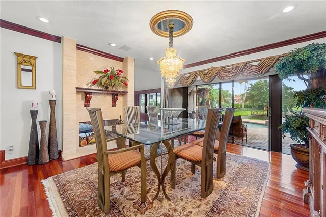 a view of a dining room with furniture a chandelier and wooden floor
