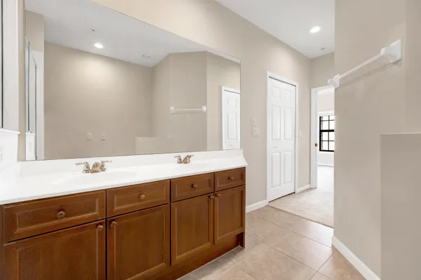 a bathroom with a double vanity sink and mirror
