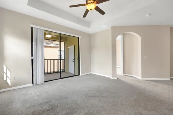 a view of a room with window and ceiling fan