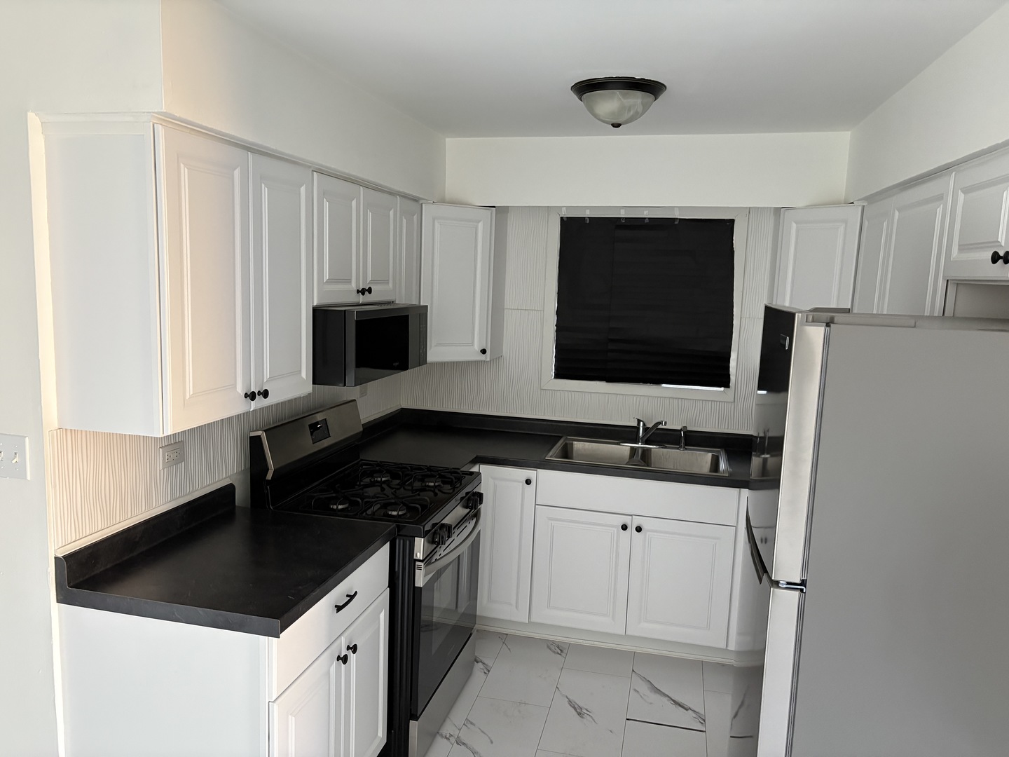 10601 Major Avenue, Unit 2S Chicago Ridge, IL 60415 - Photo 2 of 7 a kitchen with granite countertop a sink and a stove top oven