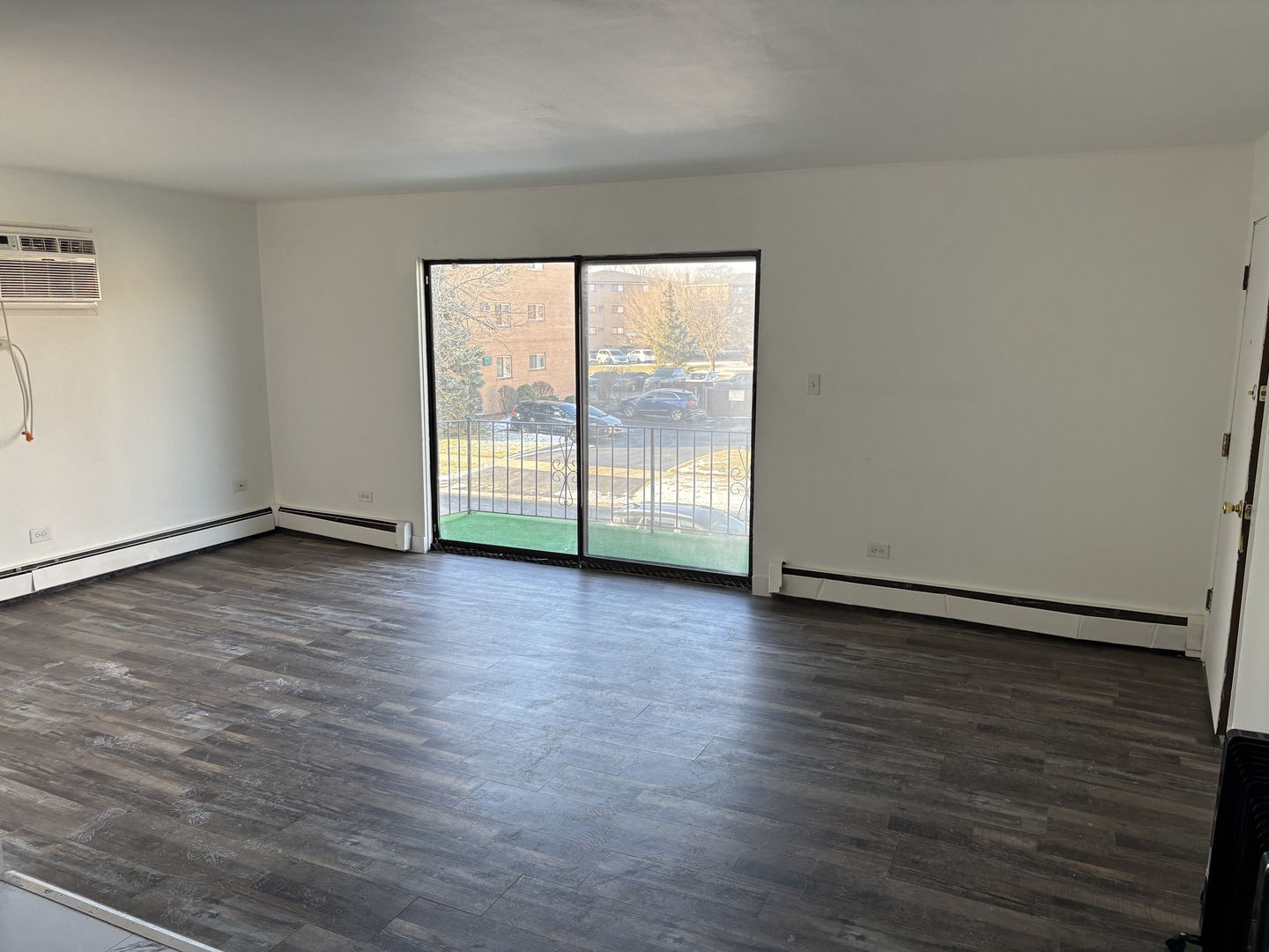 10601 Major Avenue, Unit 2S Chicago Ridge, IL 60415 - Photo 4 of 7 a view of an empty room with wooden floor and a window