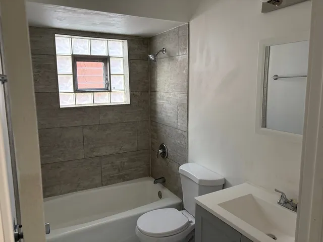 a bathroom with a toilet and a bathtub