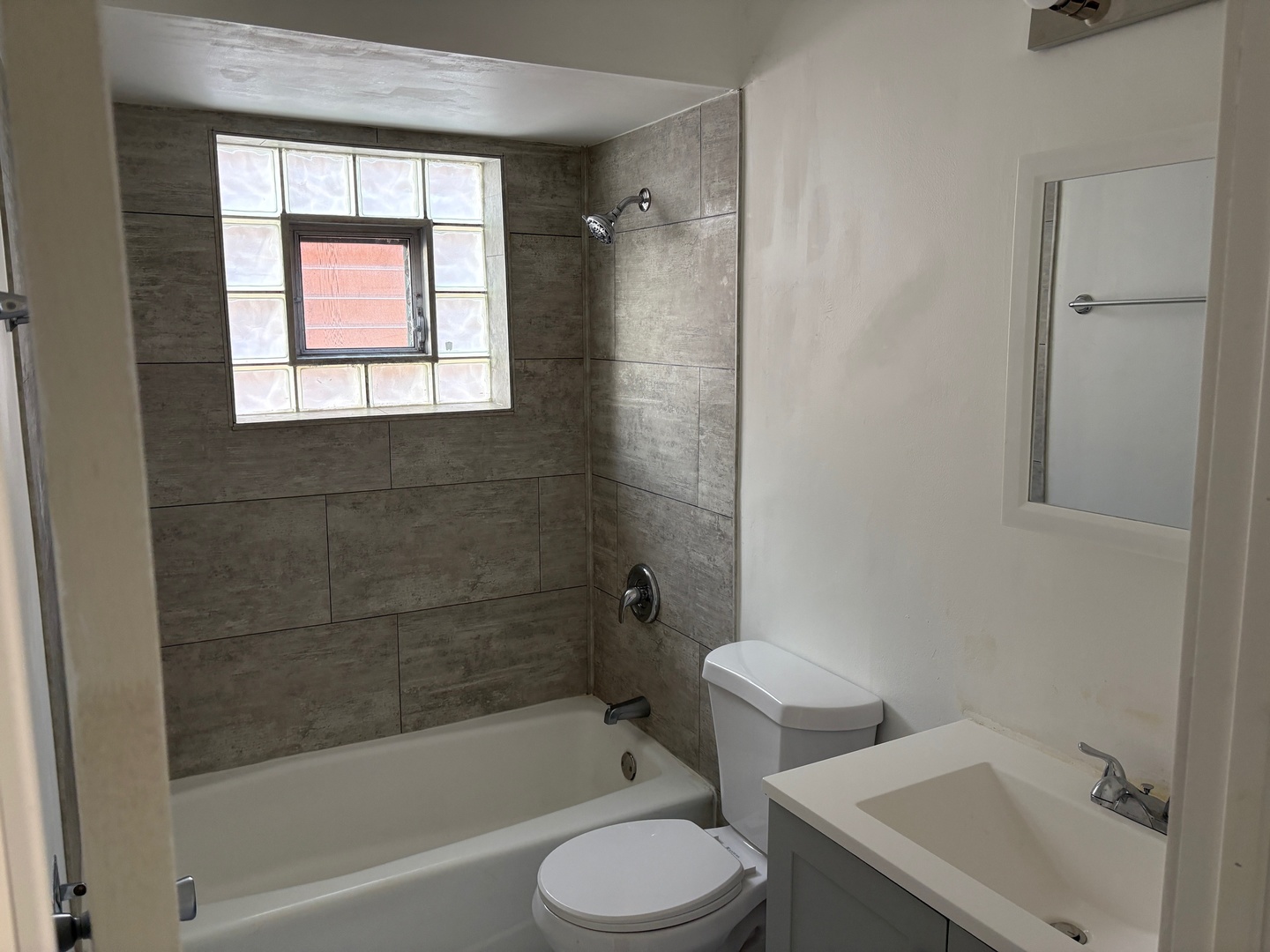 10601 Major Avenue, Unit 2S Chicago Ridge, IL 60415 - Photo 7 of 7 a bathroom with a toilet and a bathtub