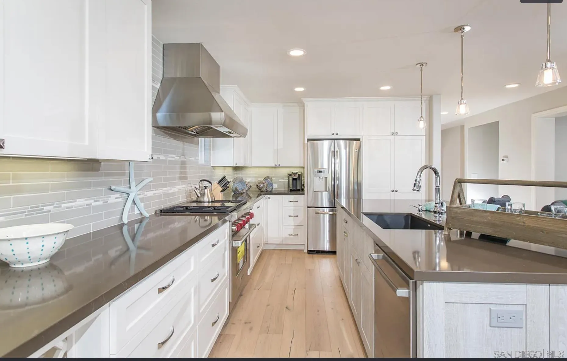 48 Spinnaker Way Coronado, CA 92118 - Photo 12 of 29 a kitchen with stainless steel appliances granite countertop a sink a stove and a refrigerator