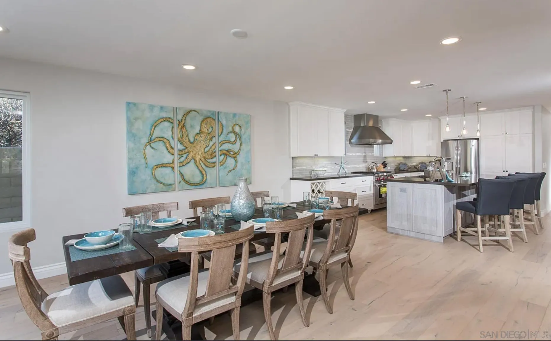 48 Spinnaker Way Coronado, CA 92118 - Photo 13 of 29 a dining area with stainless steel appliances kitchen island granite countertop a dining table chairs and a oven