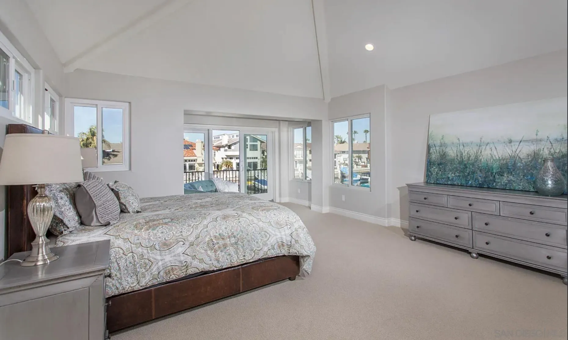 48 Spinnaker Way Coronado, CA 92118 - Photo 18 of 29 a bedroom with a large bed and dresser with mirror