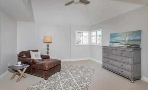 a living room with furniture and a dresser
