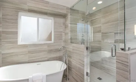 a bathroom with a bathtub and shower