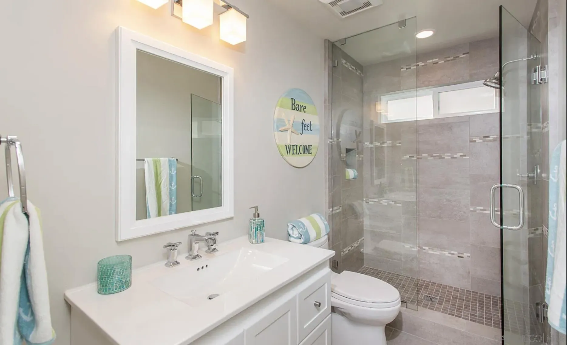 48 Spinnaker Way Coronado, CA 92118 - Photo 25 of 29 a bathroom with a sink a toilet and shower