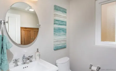 a bathroom with a sink a mirror and a toilet