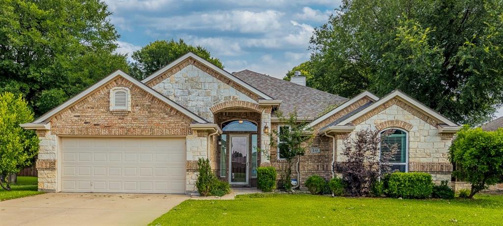 a view of house with garden and tall tress