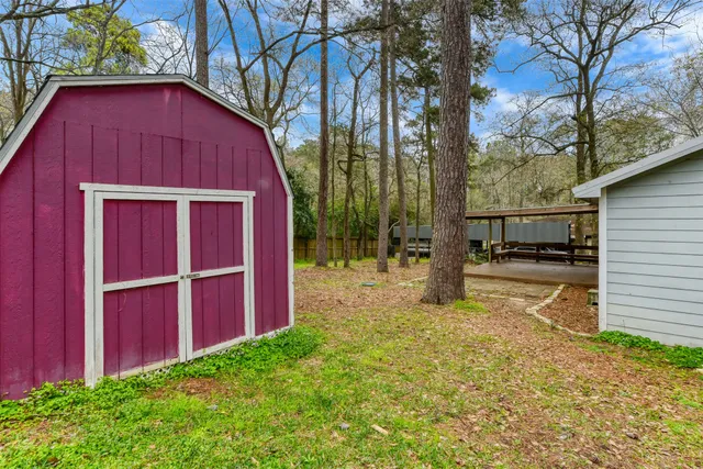 a view of backyard of house with wooden fence