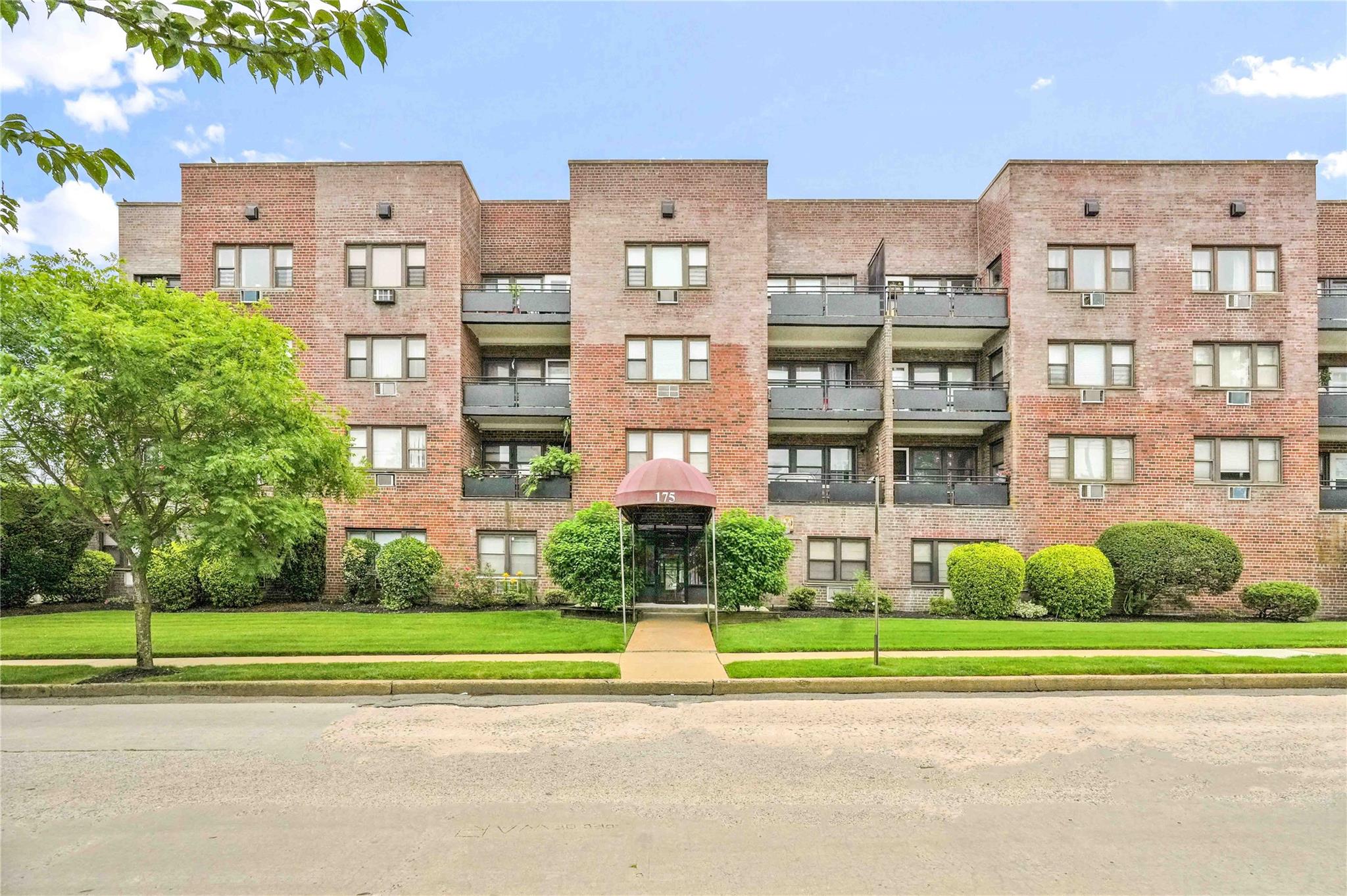 175 Archer Street, Unit 3A Freeport, NY 11520 - Photo 1 of 1 a view of a brick building next to a yard
